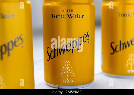 London. UK- 12.31.2022. Cans of Schweppes Indian Tonic Water in a row. Stock Photo