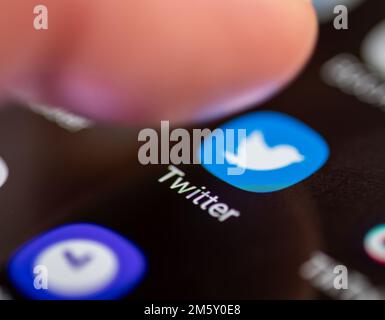 London. UK- 12.31.2022. A person pressing on the icon, symbol of the messaging, social media application Twitter on the screen of an Android smartphon Stock Photo