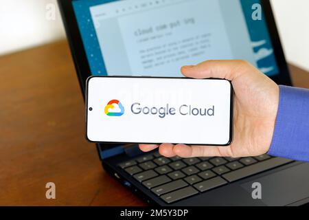 Logo of Google Cloud on a smartphone in front of a computer. Google Cloud is a cloud computing technology company. Stock Photo