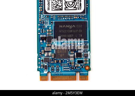 A Nanya Technology SDRAM memory chip on a M.2 SSD isolated on a white background. Nanya Technology is a Taiwanese DRAM chipmaker. Stock Photo