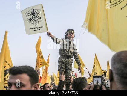 Gaza, Palestine. 31st Dec, 2022. A Palestinian child wears a keffiyeh seen waving a flag during the rally to commemorate the 58th anniversary of the founding of the Fatah movement in Gaza City. Credit: SOPA Images Limited/Alamy Live News Stock Photo