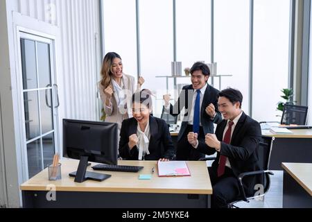Employee working in office got news from friend excited and happy together from their winning Stock Photo
