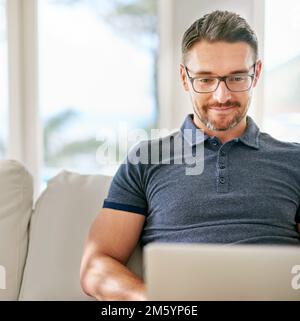 Enjoying his day off. a handsome mature man relaxing on the sofa at home. Stock Photo