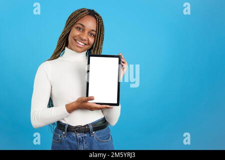 Smiling african woman showing the screen of a digital tablet Stock Photo