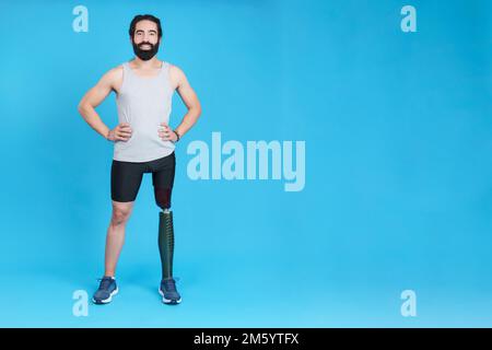Smiley man standing with a leg prosthesis Stock Photo