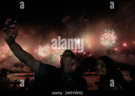 Rio De Janeiro, Brazil. 01st Jan, 2023. People watch the fireworks on Copacabana beach on New Year's Eve. Credit: Joao Gabriel Alves/dpa/Alamy Live News Stock Photo