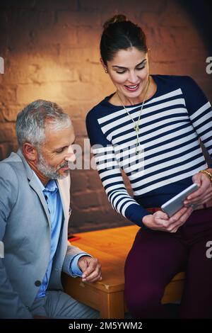 Double the ideas, double the success. coworkers using a digital tablet together. Stock Photo