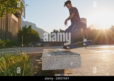 Feel the fear and do it anyway. a young man skating in the city. Stock Photo