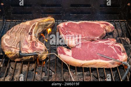 grilled t-bone Steak ( beef steak) on a barbecue with meat thermometer. Selective focus - Trentino Alto Adige, northern Italy - Europe Stock Photo