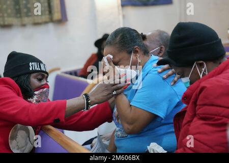St. Louis, United States. 31st Dec, 2022. Friends assist a mourner as their loved ones name is called during the Annual reading of the names of homicide victims at the Williams Temple in St. Louis on Saturday, December 31, 2022. St. Louis had 198 homicides in 2022. Photo by Bill Greenblatt/UPI Credit: UPI/Alamy Live News Stock Photo