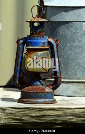 Antique rusty kerosene lamp with a glass bulb. Stock Photo