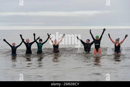 Portobello, Scotland, UK. 1st January 2023. Wild swimmers brave the cold waters of the Firth of Forth for a New Year’s Day swim at Portobello beach this morning. Iain Masterton/Alamy Live News Stock Photo