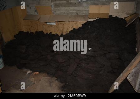 Stack of coal for heating in the basement Stock Photo