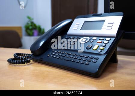 Phone device on office table, communication technology concept. Stock Photo