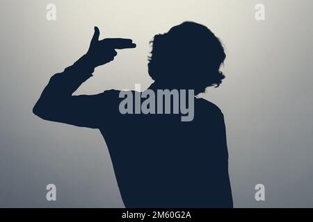 woman standing over isolated background pointing hand and fingers to head Stock Photo