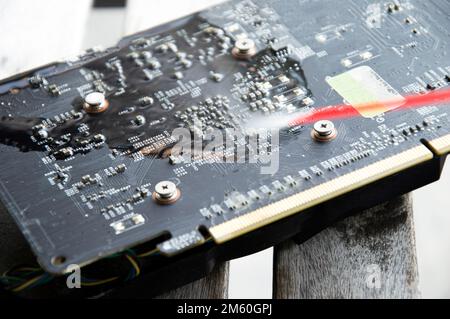 Technician view using spray to clean graphics card Stock Photo