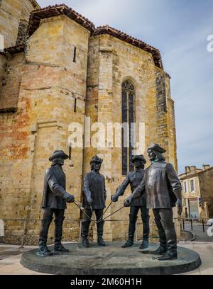 Statues of the Three Musketeers (actually 4) in front of Condom Cathedrale in the South of France (Gers) Stock Photo