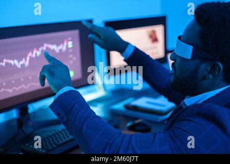 Business man making investments using virtual reality glasses to optimize his investments Stock Photo
