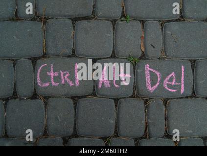 Contral, Alt, Delete Words Combination Written By Red Chalk On A Gray Paving Like On A Computer Keyboard Stock Photo