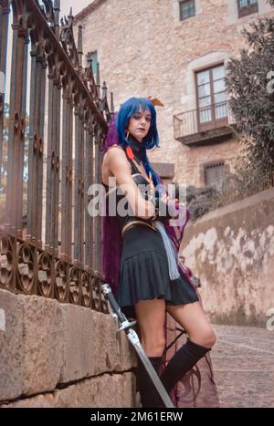 Young girls wearing a black bride like costume, warrior girl wielding a katana sword, in a medieval setting Stock Photo