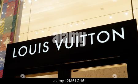 Louis Vuitton store in London at night - LONDON, UK - DECEMBER 20, 2022 Stock Photo
