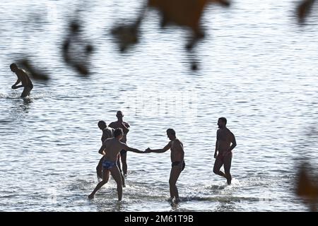 The people of Split used the sunny first day of the New Year for a picigin on Bacvice beach in Split, Croatia on January 1, 2023. Picigin is traditional ball game from Split  that is played on the beach. It is an amateur sport played in shallow water consisting of players keeping a small ball from touching the water. Stock Photo