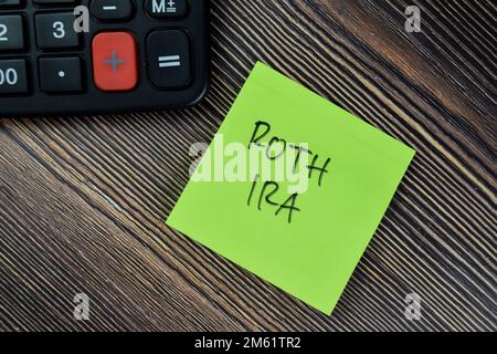 Concept of ROTH IRA write on sticky notes isolated on Wooden Table. Stock Photo