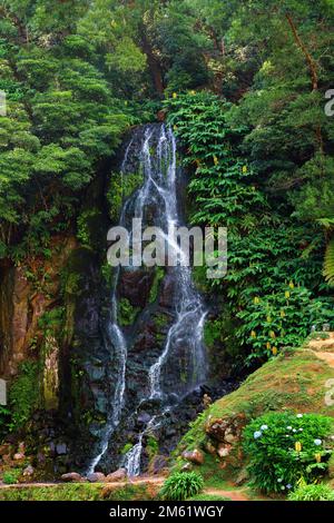 Sao Miguel Island in the Azores. Typical landscape of waterfall in flower garden. Nature as a tourist attraction and travel and vacation destination. Stock Photo