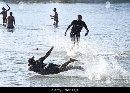 The people of Split used the sunny first day of the New Year for a picigin on Bacvice beach in Split, Croatia on January 1, 2023. Picigin is traditional ball game from Split  that is played on the beach. It is an amateur sport played in shallow water consisting of players keeping a small ball from touching the water. Stock Photo