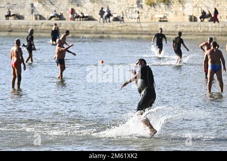 The people of Split used the sunny first day of the New Year for a picigin on Bacvice beach in Split, Croatia on January 1, 2023. Picigin is traditional ball game from Split  that is played on the beach. It is an amateur sport played in shallow water consisting of players keeping a small ball from touching the water. Stock Photo