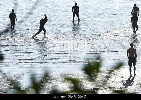 The people of Split used the sunny first day of the New Year for a picigin on Bacvice beach in Split, Croatia on January 1, 2023. Picigin is traditional ball game from Split  that is played on the beach. It is an amateur sport played in shallow water consisting of players keeping a small ball from touching the water. Stock Photo