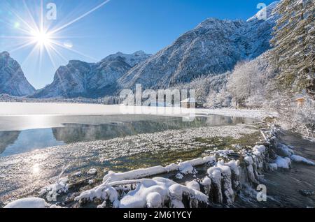 A sunny winter morning ata snowy and iced Lake Dobbiaco, Province of Bolzano, Trentino Alto Adige, Italy. Stock Photo