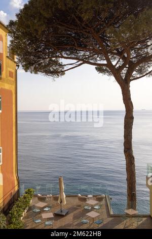 Terrace with bathing buns facing Mediterranean sea  in Camogli, a fishing village and resort close to the peninsula of Portofino, in the Riviera di Le Stock Photo