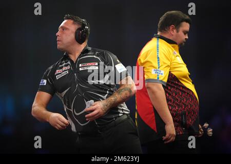 Gerwyn Price can be seen wearing ear defenders during his match against Gabriel Clemens on day fourteen of the Cazoo World Darts Championship at Alexandra Palace, London. Picture date: Sunday January 1, 2023. Stock Photo