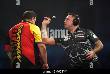 Gerwyn Price can be seen wearing ear defenders during his match against Gabriel Clemens on day fourteen of the Cazoo World Darts Championship at Alexandra Palace, London. Picture date: Sunday January 1, 2023. Stock Photo