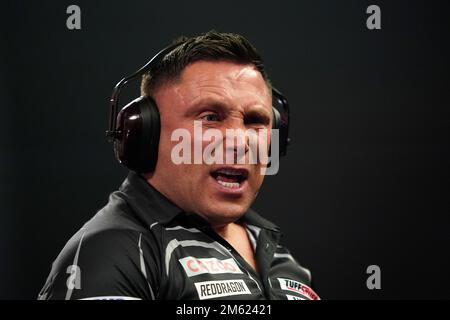 Gerwyn Price can be seen wearing ear defenders during his match against Gabriel Clemens on day fourteen of the Cazoo World Darts Championship at Alexandra Palace, London. Picture date: Sunday January 1, 2023. Stock Photo