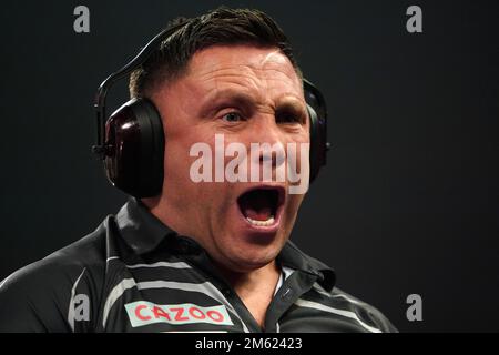 Gerwyn Price can be seen wearing ear defenders during his match against Gabriel Clemens on day fourteen of the Cazoo World Darts Championship at Alexandra Palace, London. Picture date: Sunday January 1, 2023. Stock Photo