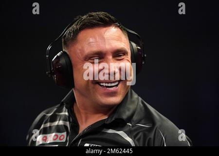 Gerwyn Price can be seen wearing ear defenders during his match against Gabriel Clemens on day fourteen of the Cazoo World Darts Championship at Alexandra Palace, London. Picture date: Sunday January 1, 2023. Stock Photo