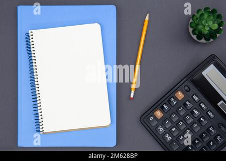 Blank notepad, calculator and pencil, top view. Stock Photo