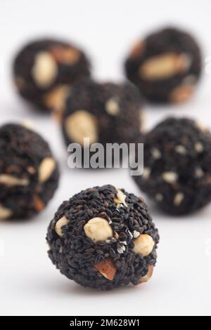 Indian Winter Delicacy Black Ball Shaped Kaala Tilgul Laddu Or Kale Til Ki Laddo Is Made Of Roasted Sesame Seed, Jaggery, Gur, Peanut, Gud, Mungfali I Stock Photo