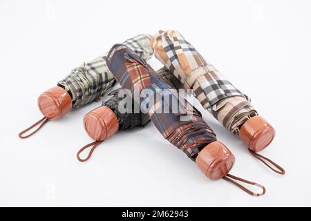 Four Umbrellas Closed; Photo On White Background. Stock Photo