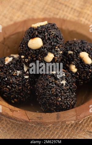 Indian Winter Delicacy Black Ball Shaped Kaala Tilgul Laddu Or Kale Til Ki Laddo Is Made Of Roasted Sesame Seed, Jaggery, Gur, Peanut, Gud, Mungfali I Stock Photo