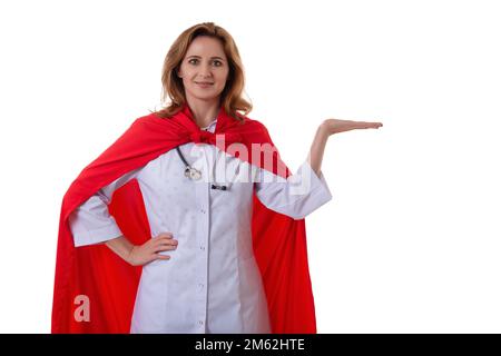 young beautiful female hospital doctor superhero making presentation posture and showing open palm gesture face to camera isolated on white background Stock Photo
