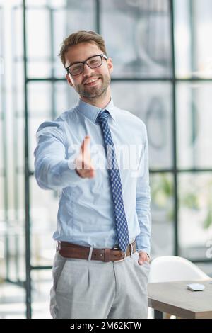 portrait confident smiling businessman offering hand for handshake Stock Photo