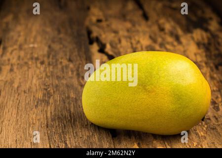 mango on a dark wood background. Stock Photo