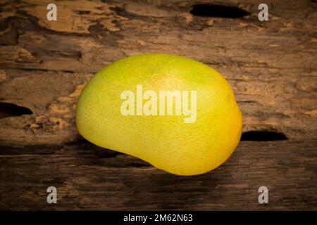mango on a dark wood background. Stock Photo