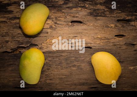 mango on a dark wood background. Stock Photo