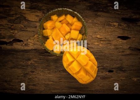 mango on a dark wood background. Stock Photo
