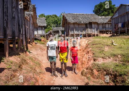 School children coming home after school in Ampahantany traditional village, Madagascar, Africa Stock Photo
