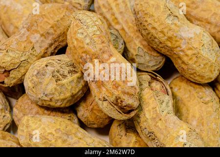 Macro shot of salted and roasted in the shell peanuts Stock Photo